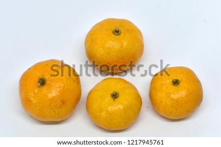 Tangerines are arranged on a white background.