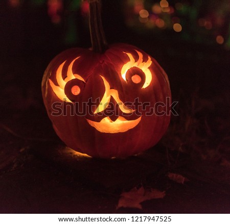 lady with eyelashes carved on pumpkin