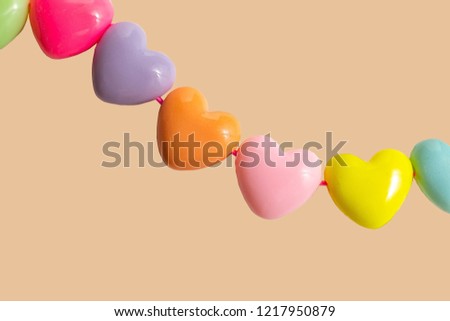 Photo frame from plastic hearts of different colors on colored backgrounds