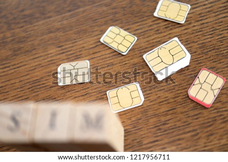 Wooden Block text of "SIM" and SIM cards