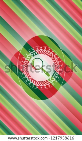 magnifying glass icon inside christmas colors badge.