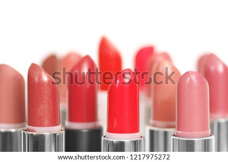 Set of colorful lipsticks close-up on white background. Shallow DOF.