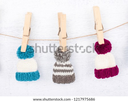 knitted hat on clothespins