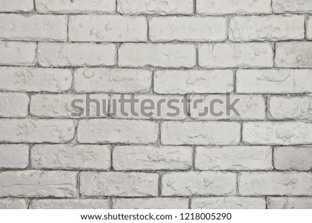 Beautiful background of a white brick wall. Textured structure. Decorative abstract design. Image of a beautiful brickwork.