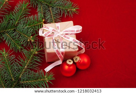 Christmas gifts with red ribbon on red background with decorations. Christmas background with copy space.