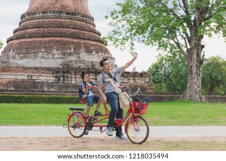 Asian young father and his son travel to Sukhothai Historical Park on vacation, landmarks in Thailand

