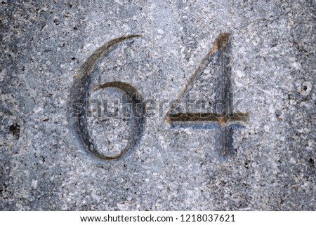 Image of the number 64 on a wall indicating a house number
