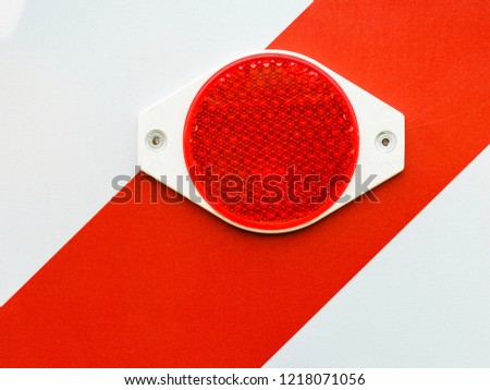 Close up of reflecting red elements, warning reflectives, danger problem white stripes.