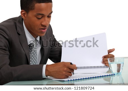 Businessman reviewing a report Royalty-Free Stock Photo #121809724