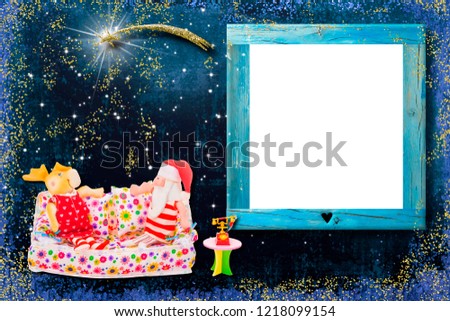Christmas photo frame greeting card.Santa Claus and the reindeer sitting on a sofa next to the phone and the star of Bethlehem in a starry sky with an empty frame for photos or messages