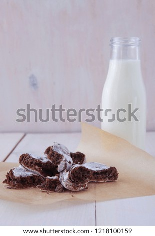Delicious breakfast. Milk and cookies on a white wooden table. Photo of chocolate dessert and beverage 