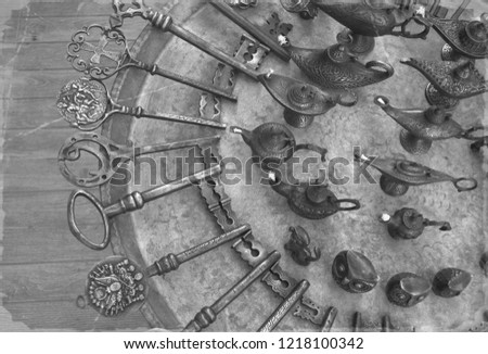 antique Ottoman door keys and oil lamps lie on a metal tray. picture stylized antique, background texture. Toned.