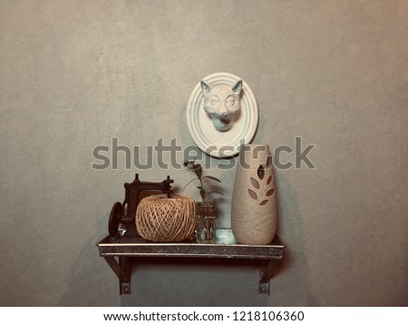 Spa Decorative items on wall shelf. Frankincense oil, Aromatherapy, Tree in a glass pot and decorative materials on wall shelf in spa and massage room. Royalty-Free Stock Photo #1218106360