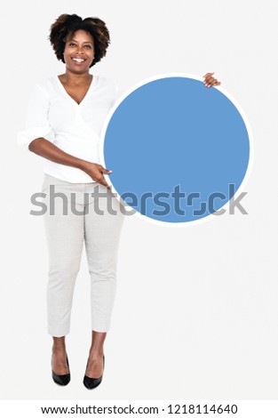 Cheerful businesswoman holding a blue round board