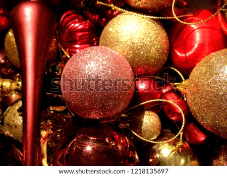 Christmas tree ornaments. Red, shiny, glittered and golden balls.