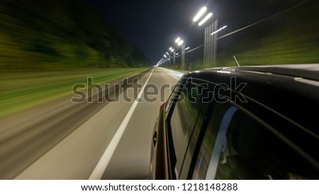 Drivelapse from Side of Car moving on a night highway timelapse hyperlapse, road with lights reflected on car on high speed. Rapid rhythm of a modern city.