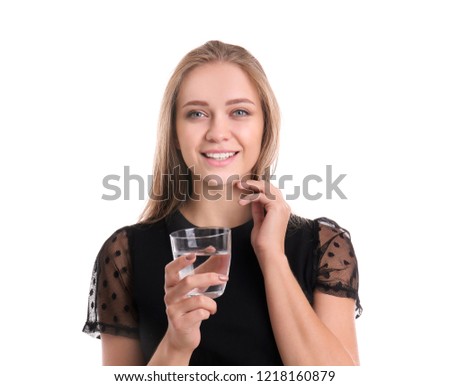 Beautiful young woman drinking water on white background