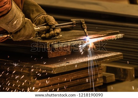 close up acetylene torch cutting metalwork with bright sparks Royalty-Free Stock Photo #1218190090