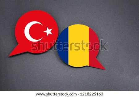 Turkey and Romania flags with two speech bubbles on dark gray background