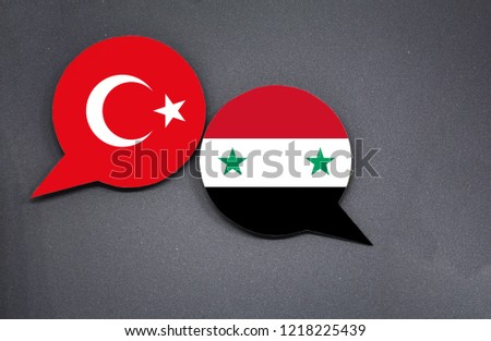 Turkey and Syria flags with two speech bubbles on dark gray background