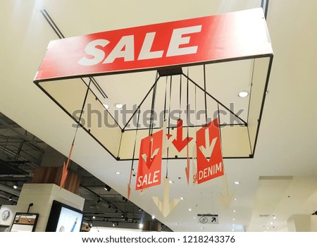 Sale sign at shopping mall that hanging from the ceiling to show that stuff in that area is sale. Shopping and sale concept.