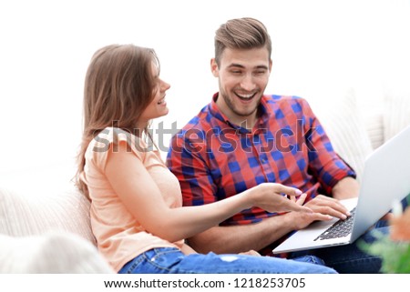 young woman showing her boyfriend's photo on the laptop.