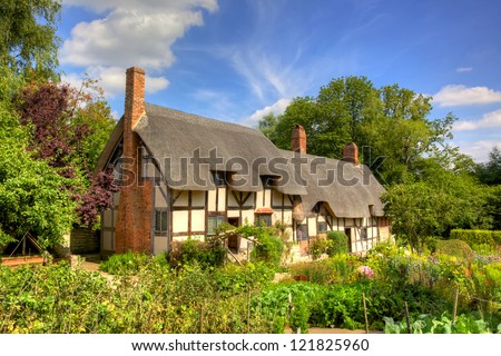 Anne Hathaway's (William Shakespeare's wife) famous thatched cottage and garden at Shottery, just outside Stratford upon Avon, England. Royalty-Free Stock Photo #121825960