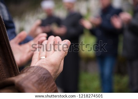 quran holy book reading by imam  on islamic funeral with white thumb stones graweyard background Royalty-Free Stock Photo #1218274501