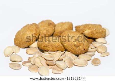 Cookies and almonds. Cookies with several almonds, isolated on white background. Selective focus