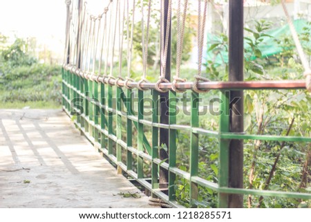 Suspension bridge, Crossing the river, ferriage in the woods. Royalty-Free Stock Photo #1218285571