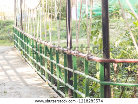 Suspension bridge, Crossing the river, ferriage in the woods. Royalty-Free Stock Photo #1218285574