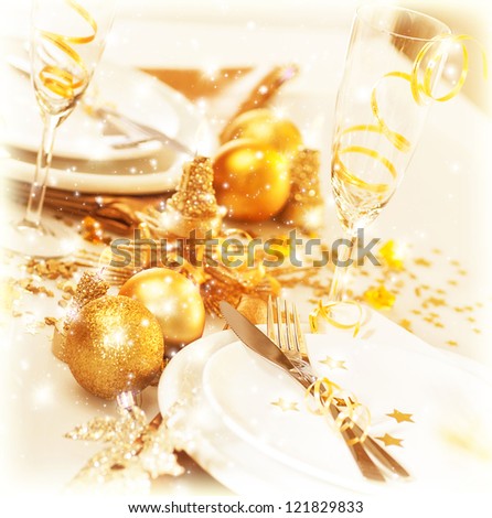 Picture of luxury festive table setting, beautiful white utensil decorated with golden balls and candles, elegant plate served with cutlery, Christmas home interior, New Year dinner