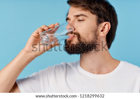 man drinking water from a glass                    