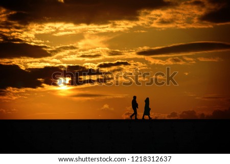 Sunrise and two people silhouette 3