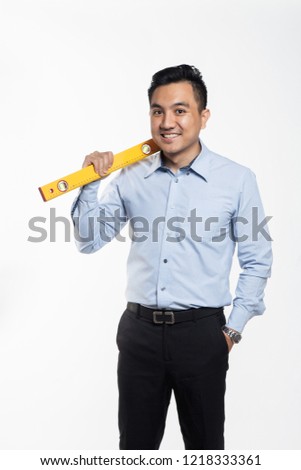 Asian contractor engineer carrying bubble level tool