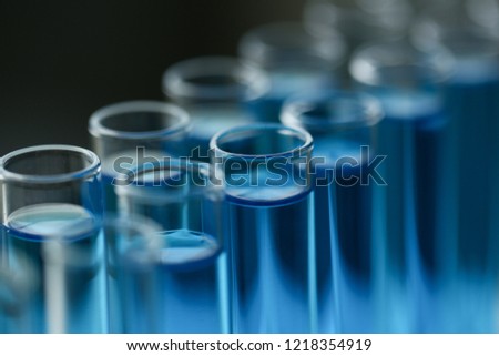Test tube of glass overflows new liquid solution potassium blue conducts an analysis reaction takes various versions reagents using chemical pharmaceutics cancer manufacturing . Royalty-Free Stock Photo #1218354919