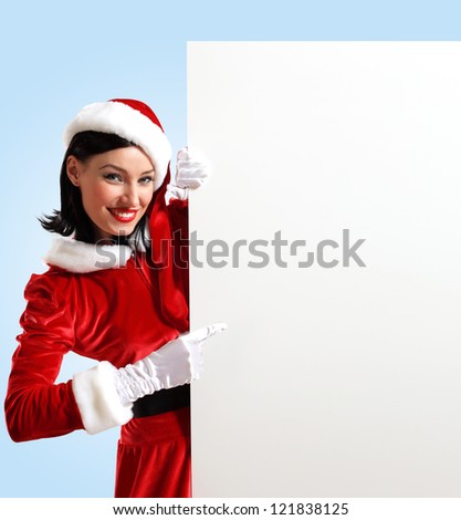 Portrait of a santa girl with a blank banner