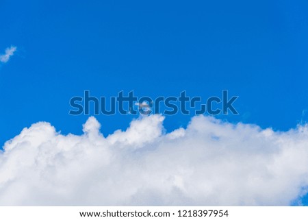 The blue sky in sunny summer weather, a cloudy background with space for putting text