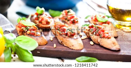 bruschetta, on slices of toasted baguette garnished with basil