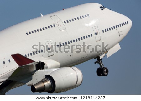 Modern civil wide-body airliner with four engines taking off at the airport Royalty-Free Stock Photo #1218416287