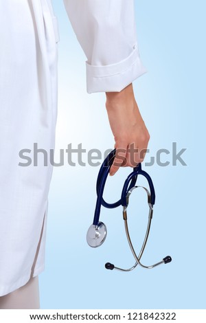 Portrait of happy successful young female doctor holding a stethoscope