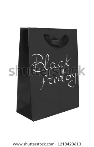 Black paper package with the words Black friday.discount period in shops