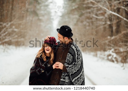
a couple of lovers positive emotions, a funny couple in love who walks through the woods in winter