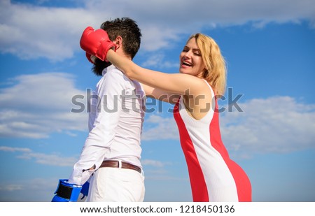 Couple in love boxing gloves blue sky background. Girl close his eyes boxing gloves. Cunning strategy win. Savvy key to success. Blind boxer can not attack opponent. Girl use cunning trick in fight.