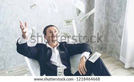 Happy business man very rich guy throw money dollar bills in air like rain money bill and banknotes US dollar bill on the bathtub - business success concept