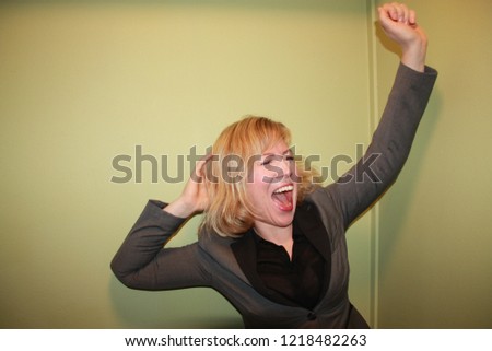 Women in a gray suit feeling ecstatic