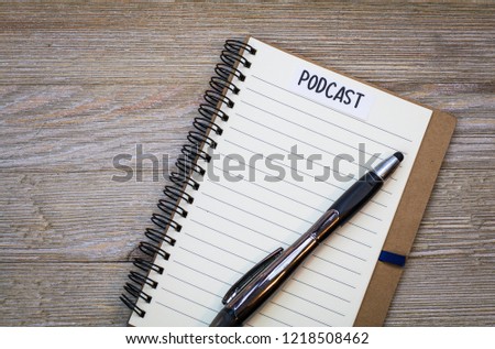 Podcast ideas concept with notebook, flat lay on wooden board