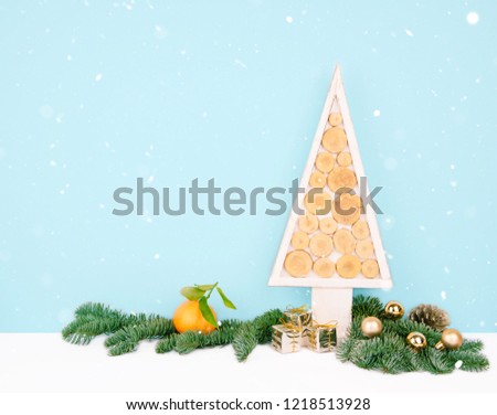Christmas wooden tree over dark light blue background. Eco style with space for your text.