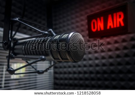 Professional microphone in radio station studio and on air sign Royalty-Free Stock Photo #1218528058