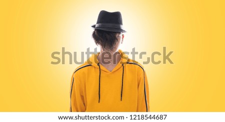 young fashioned teenager isolated in yellow background